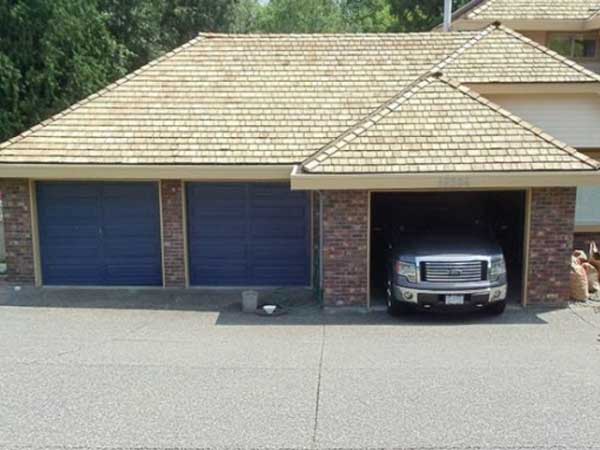 Before image of a clogged gutter at a commercial or residential property, filled with leaves and debris.